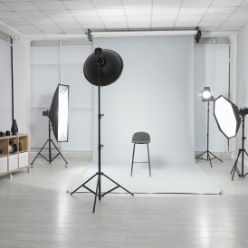 Empty,Chair,And,Professional,Equipment,In,Photographer's,Studio